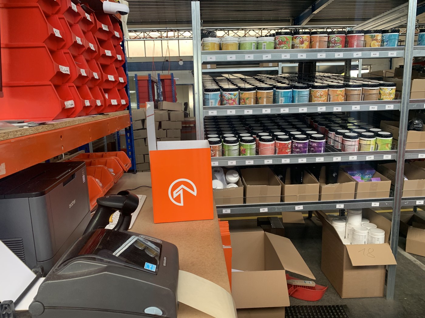 LevlUp fulfilment warehouse with product shelves and packing stations